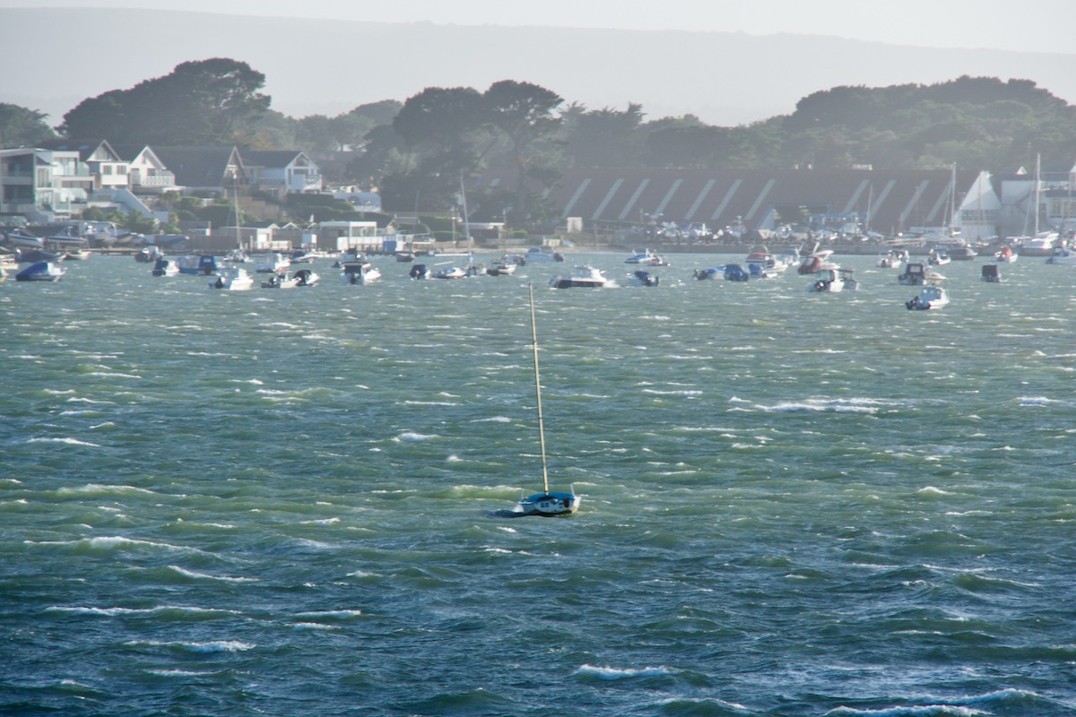 A Solitary Sailboat on Stormy Waters in Poole Harbour, Dorset