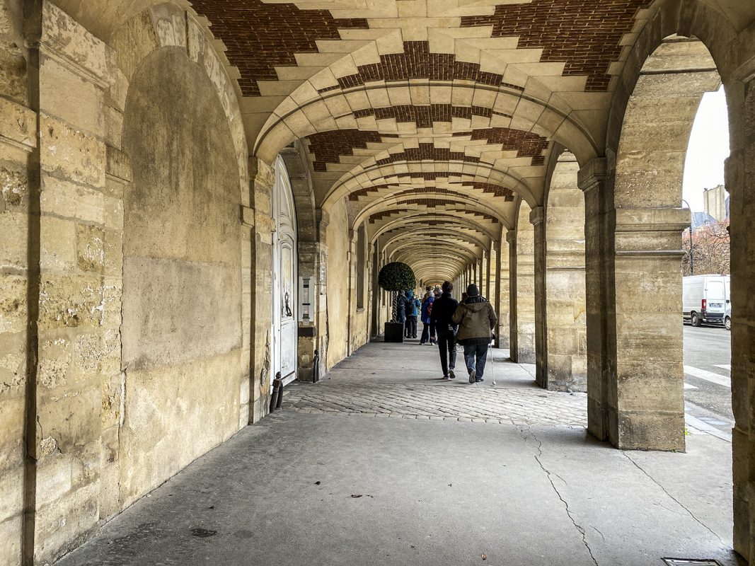 Arcade in Place des Vosges in the Maraisna district of Paris IMG 3699
