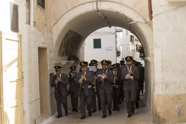 Band marching through the historic centre of Monopoli, Puglia in Italy