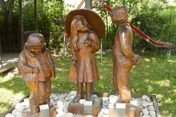 Carved figures in a playground in Praso in Trentino a region of Italy