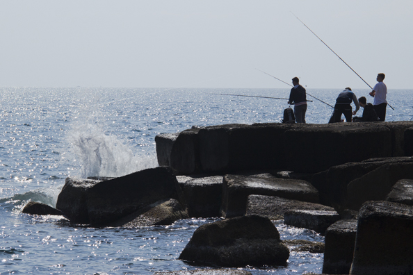 Fishing on the sea front in Monopoli, Puglia in Italy