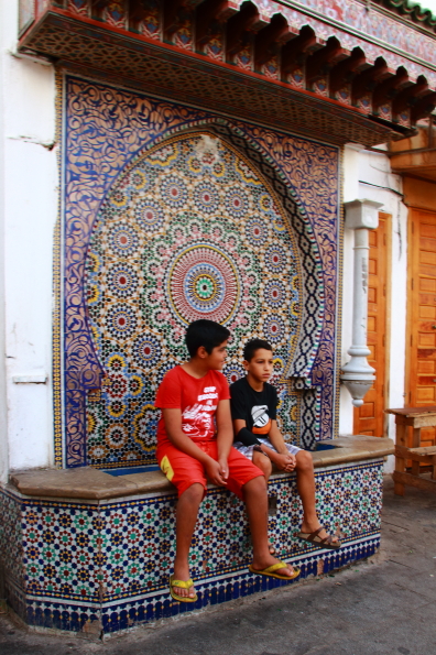 Passing the time of day on a fountain in the medina in Rabat Morocco