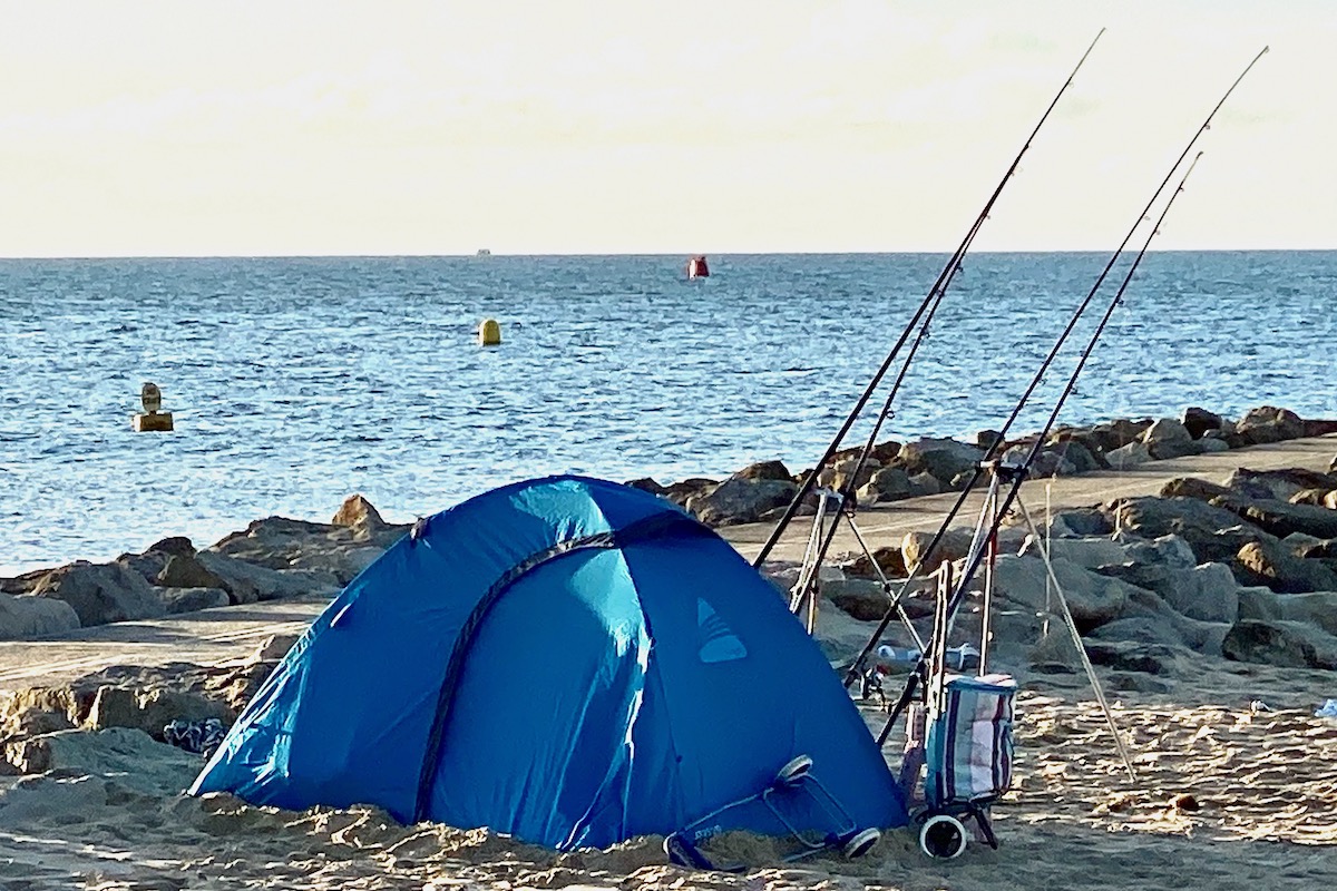 Keen Fishermen Camping on Sandbanks Beach in Dorset
