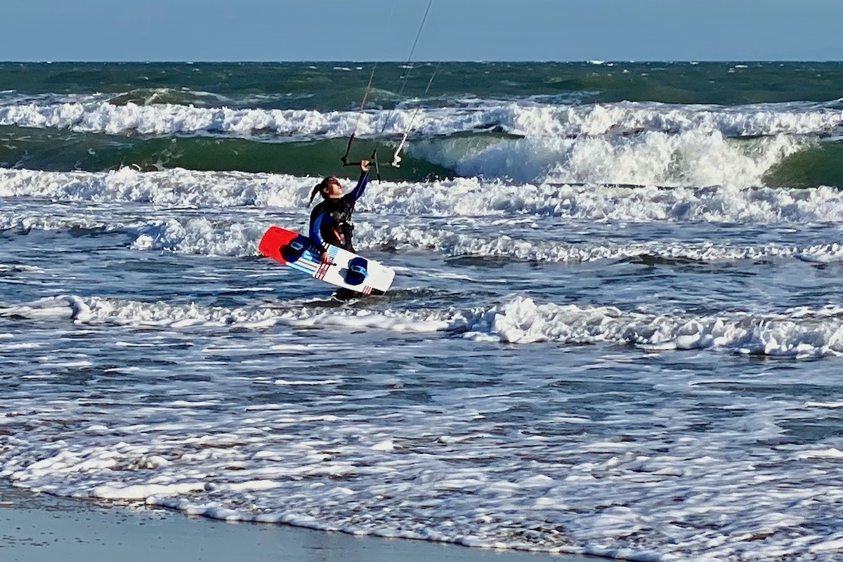 Kite Boarder Struggles in the Wind on Sandbanks Beach in Dorset