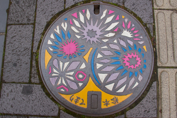 Matsumoto-temari, its folkcraft balls, on a pavement plaque in Matsumoto, Japan