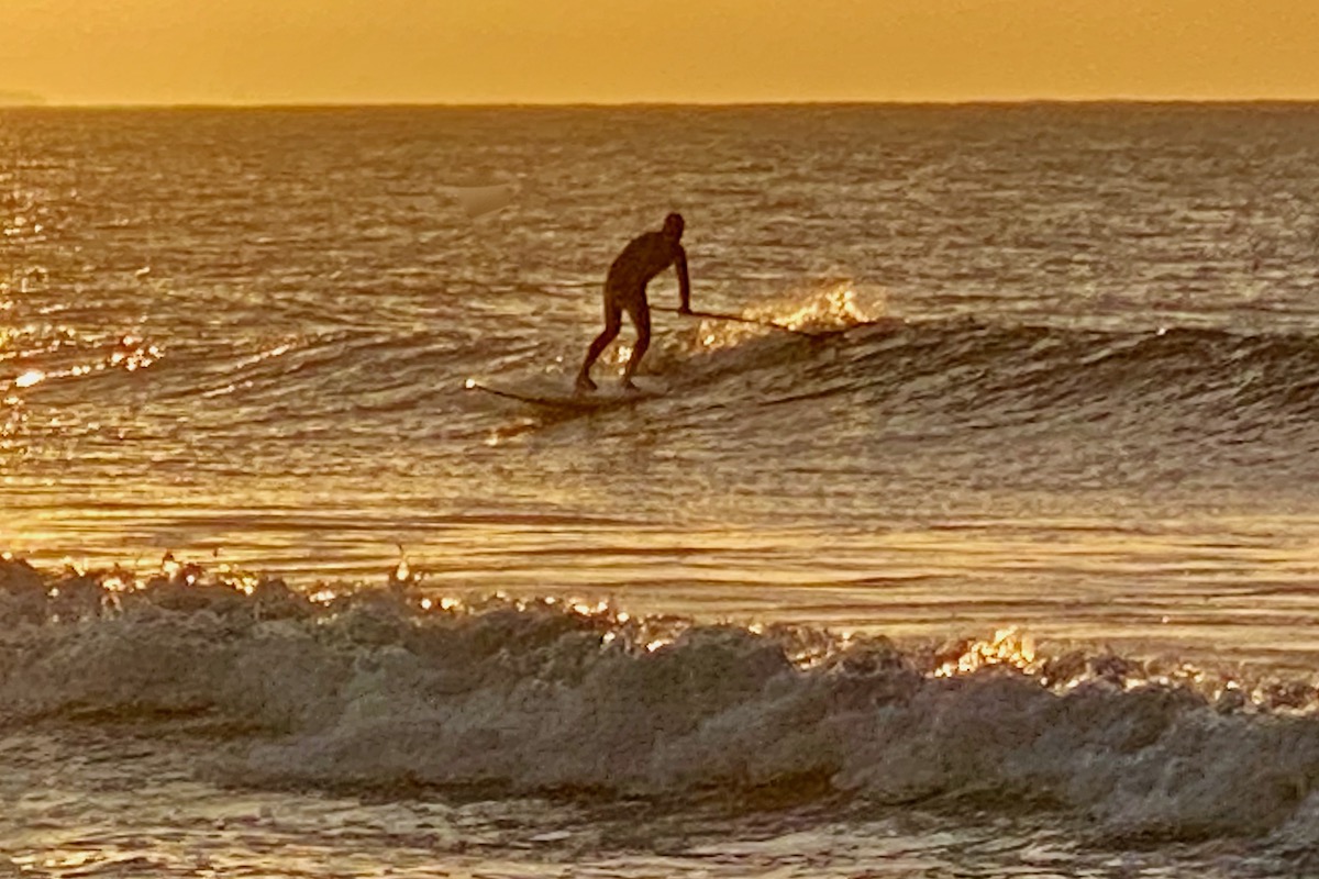 Paddleboarder Surfing off Sandbanks Beach in Dorset