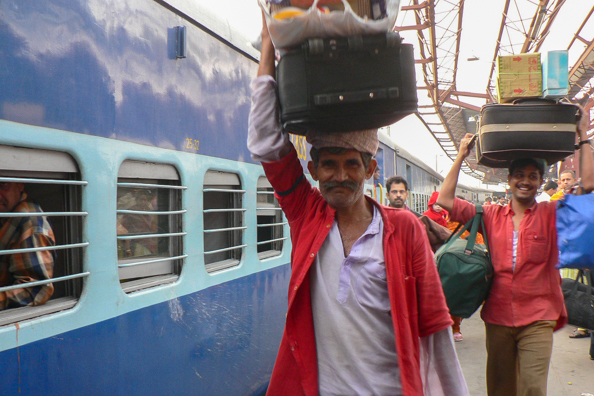 Porters carrying luggage in India