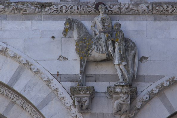 Saint Martin on his horse - detail from the facade of the Cattedrale di San Martino in Lucca, Tuscany in Italy