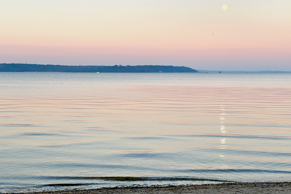 Snow Moon and the Sun Rising over Poole Harbur in Dorset