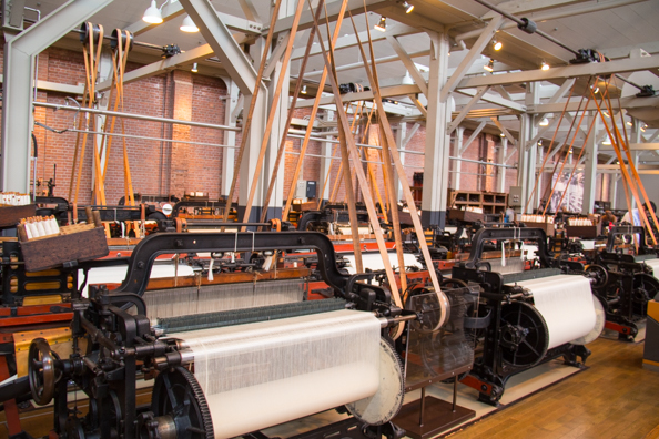Working weaving machines in the Textile Machinery Pavilion of the Toyota Museum in Nagoya, Japan